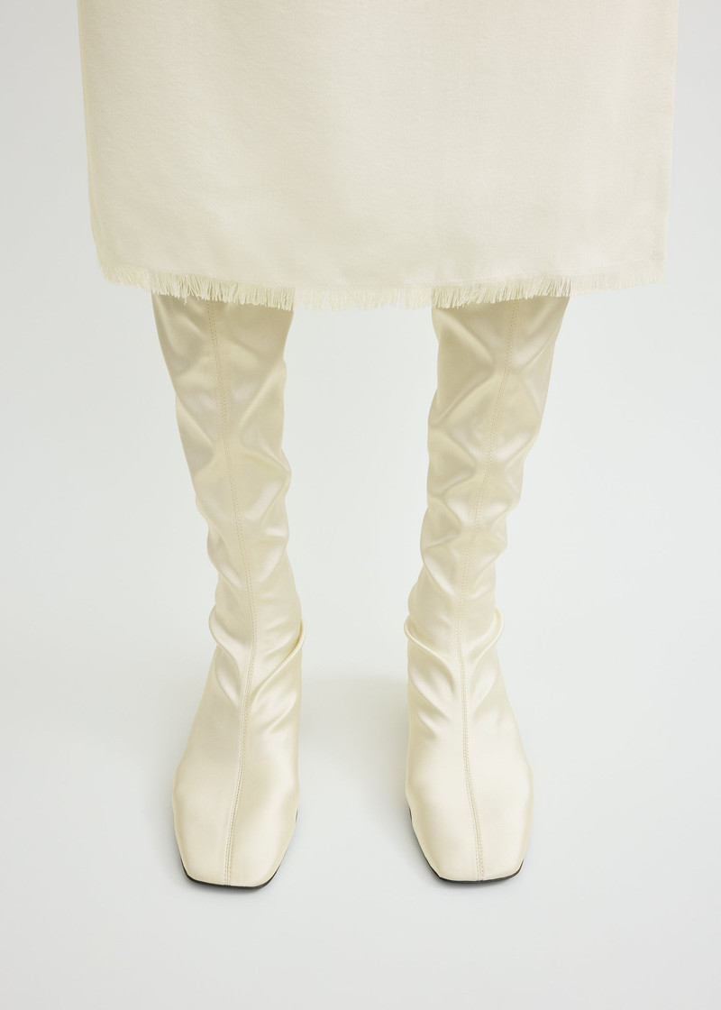 Totême Satin knee-high boots milk outlook