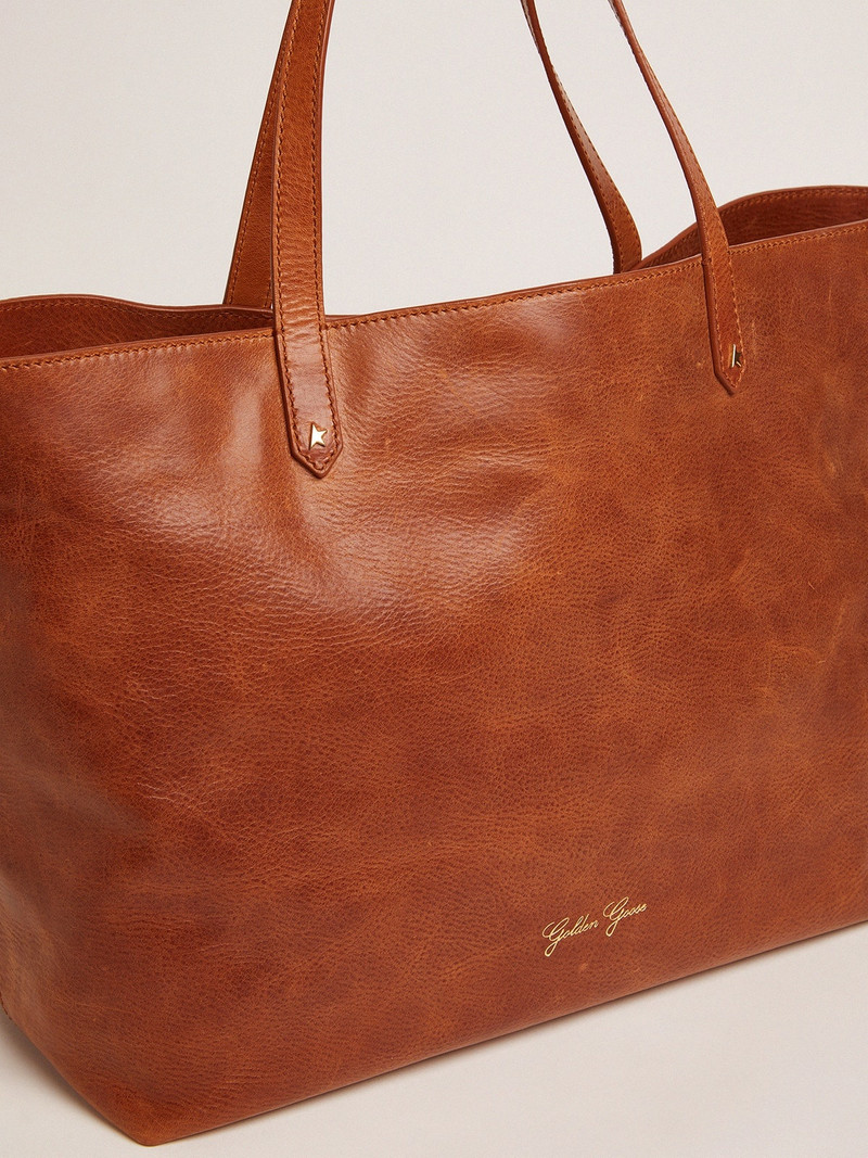 Golden Goose Pasadena Bag in tan-colored glossy leather with gold logo on the front outlook