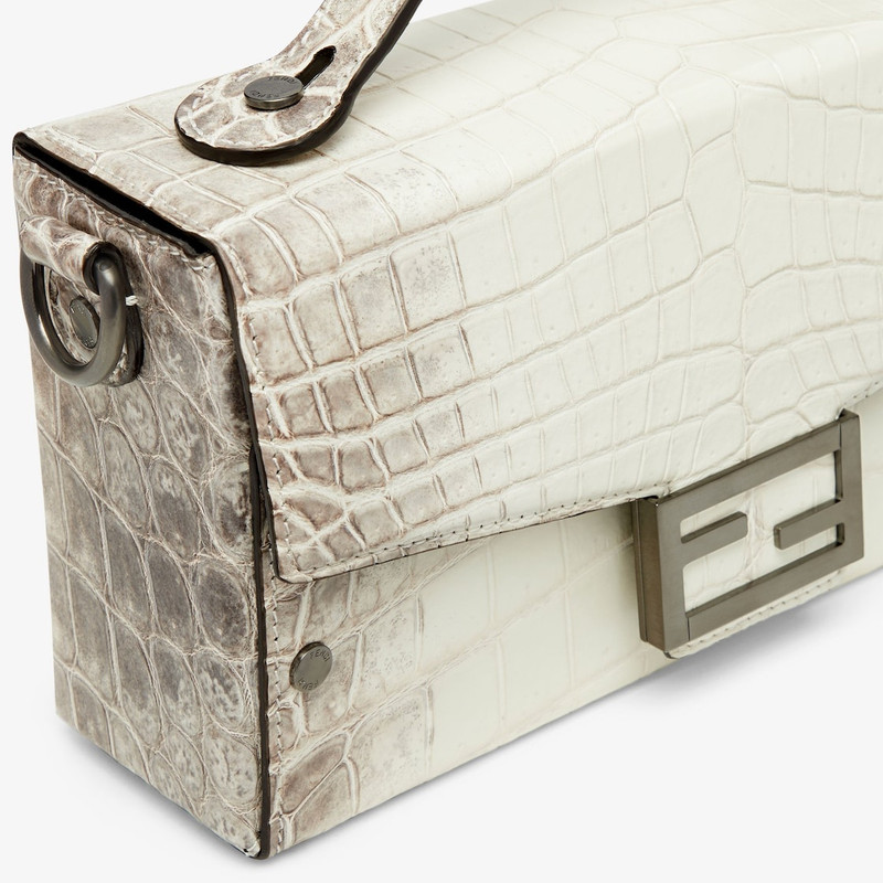 Small Baguette Soft Trunk made of exquisite crocodile leather in white with dark gray nuances. Flap  5