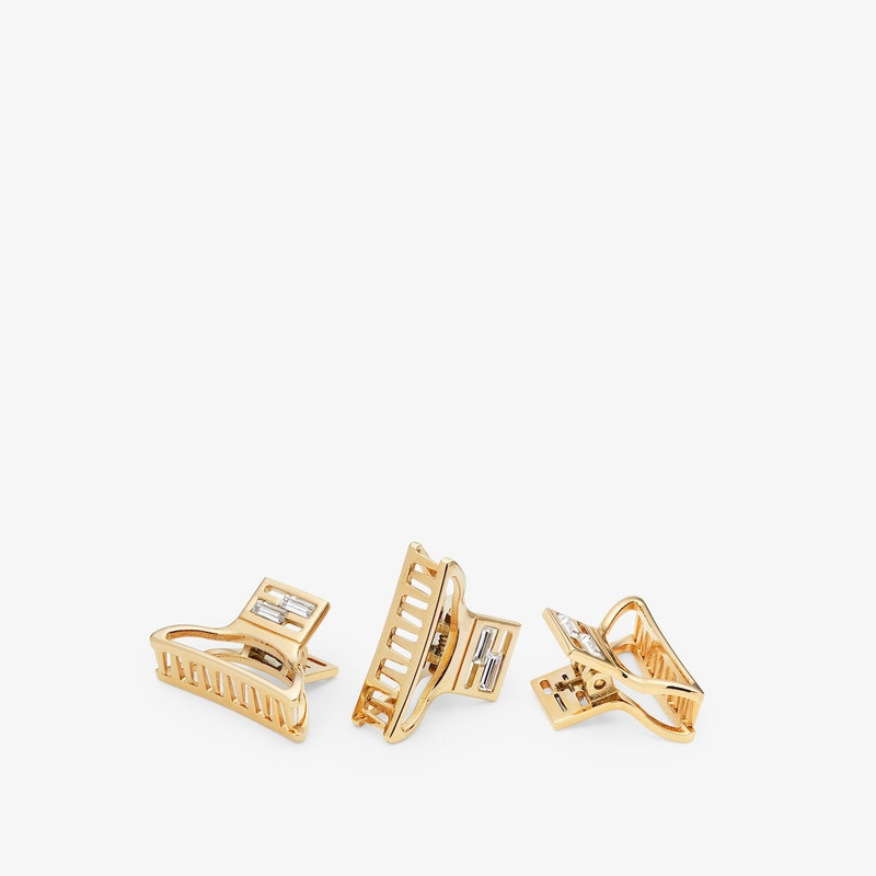 Set of three hair clips with FF Baguette motif. Made of metal with a gold finish. Decorated with Bag 1
