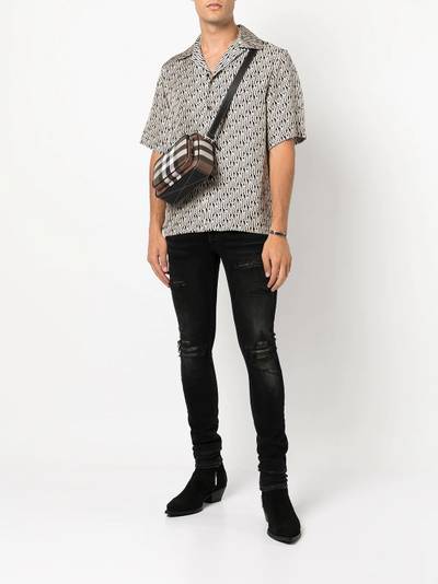 AMIRI distressed skinny jeans outlook