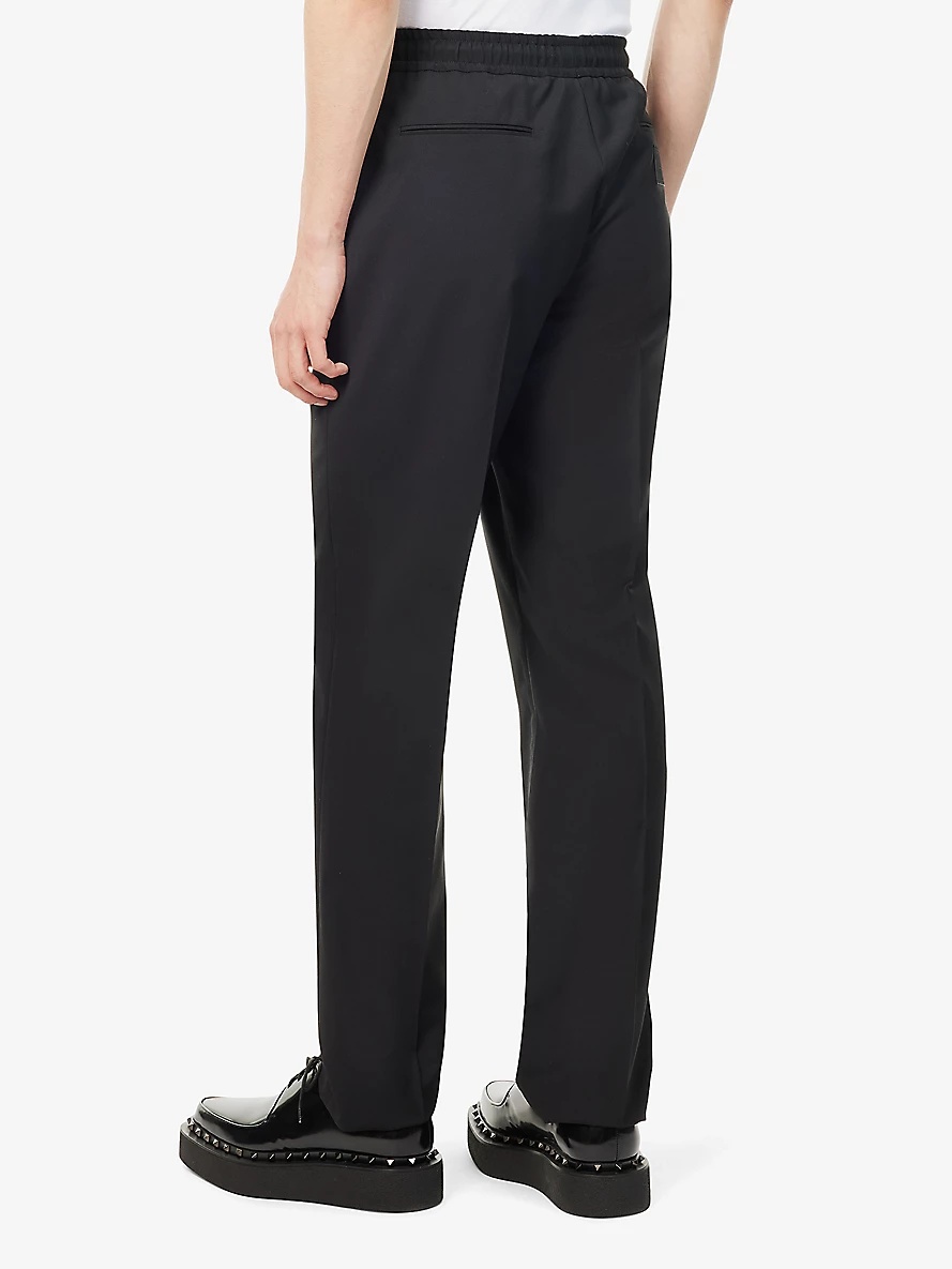 Brand-appliqué tapered-leg wool-blend trousers - 4