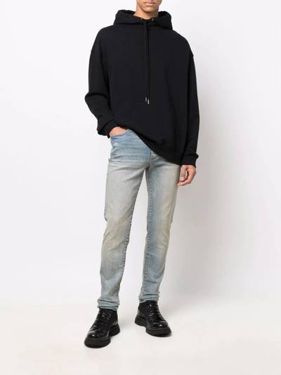 AMIRI logo-patch stonewashed skinny jeans outlook