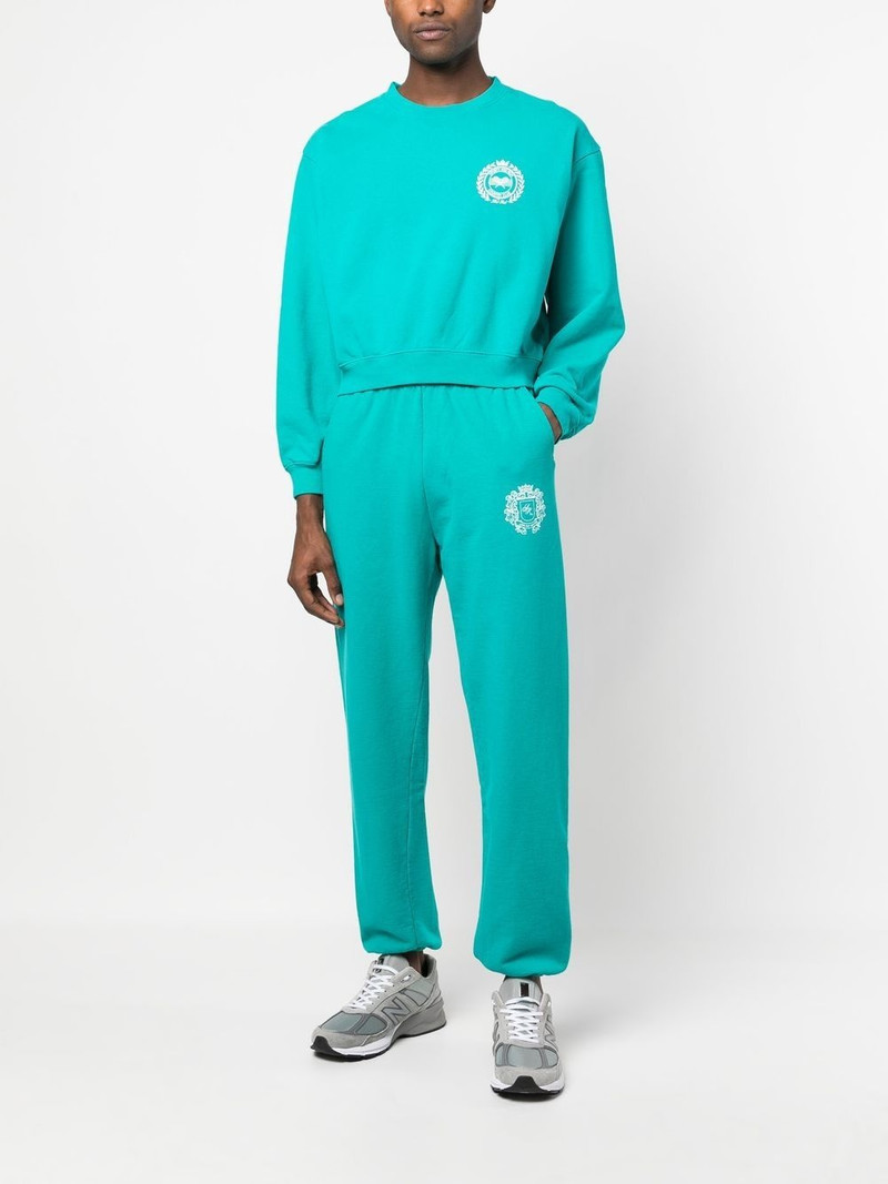 Sporty & Rich crest logo print track pants outlook