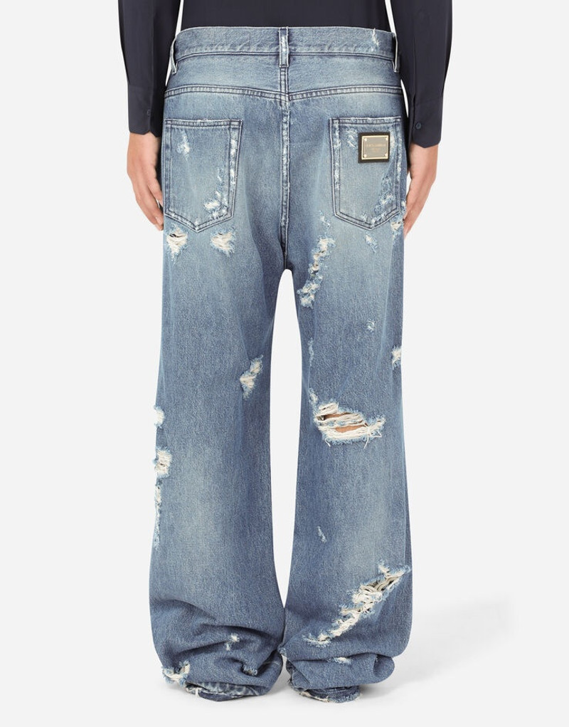 Oversize light blue wash jeans with rips 3