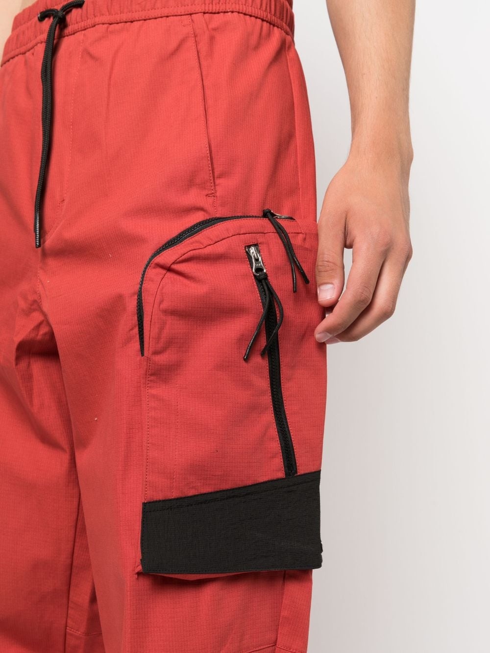 Overset Tech logo-print trousers - 5