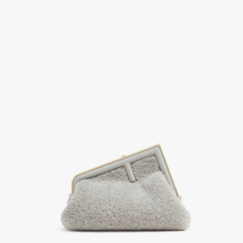 Small Fendi First bag made of soft, pale gray sheepskin with oversized metal F clasp bound in tone o 1