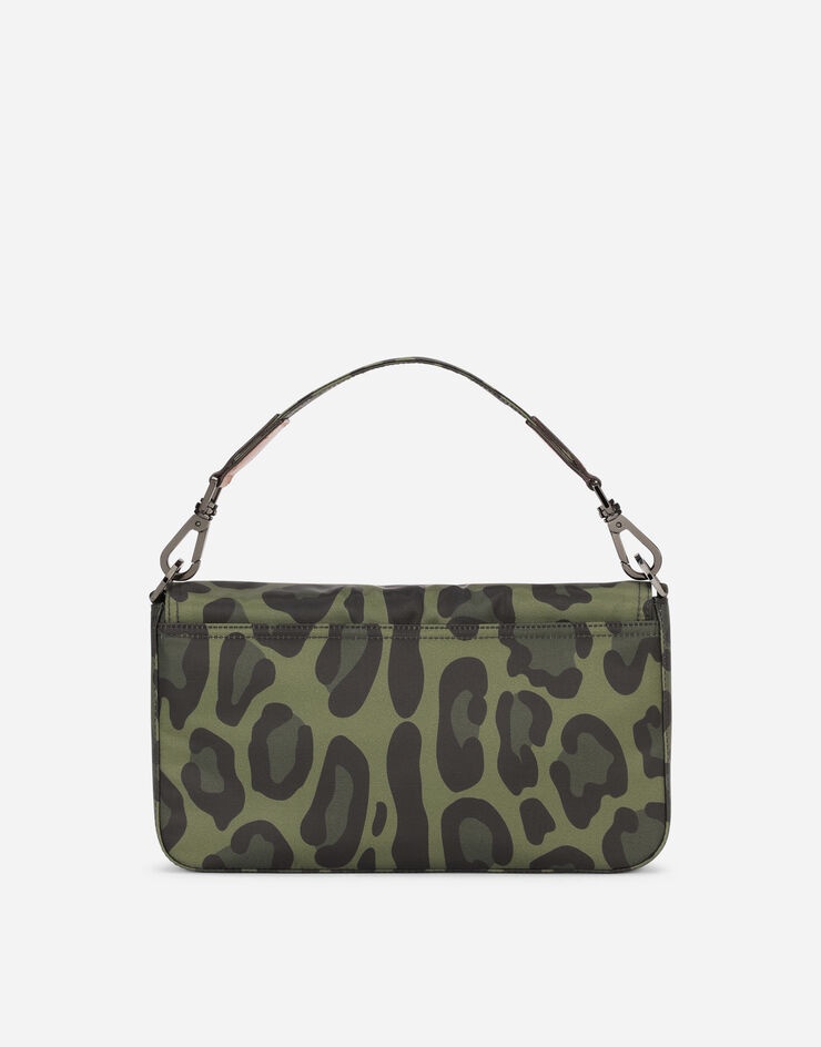 Nylon crossbody bag with leopard print against a green background and branded plate - 4