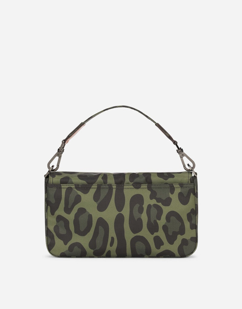 Nylon crossbody bag with leopard print against a green background and branded plate 4