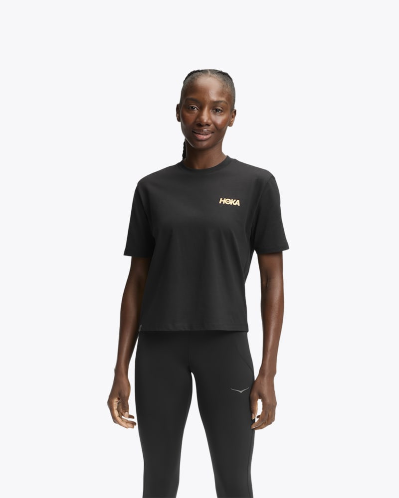 Women's HOKA Manifesto Short Sleeve Tee Shirt in Black/Gold 1