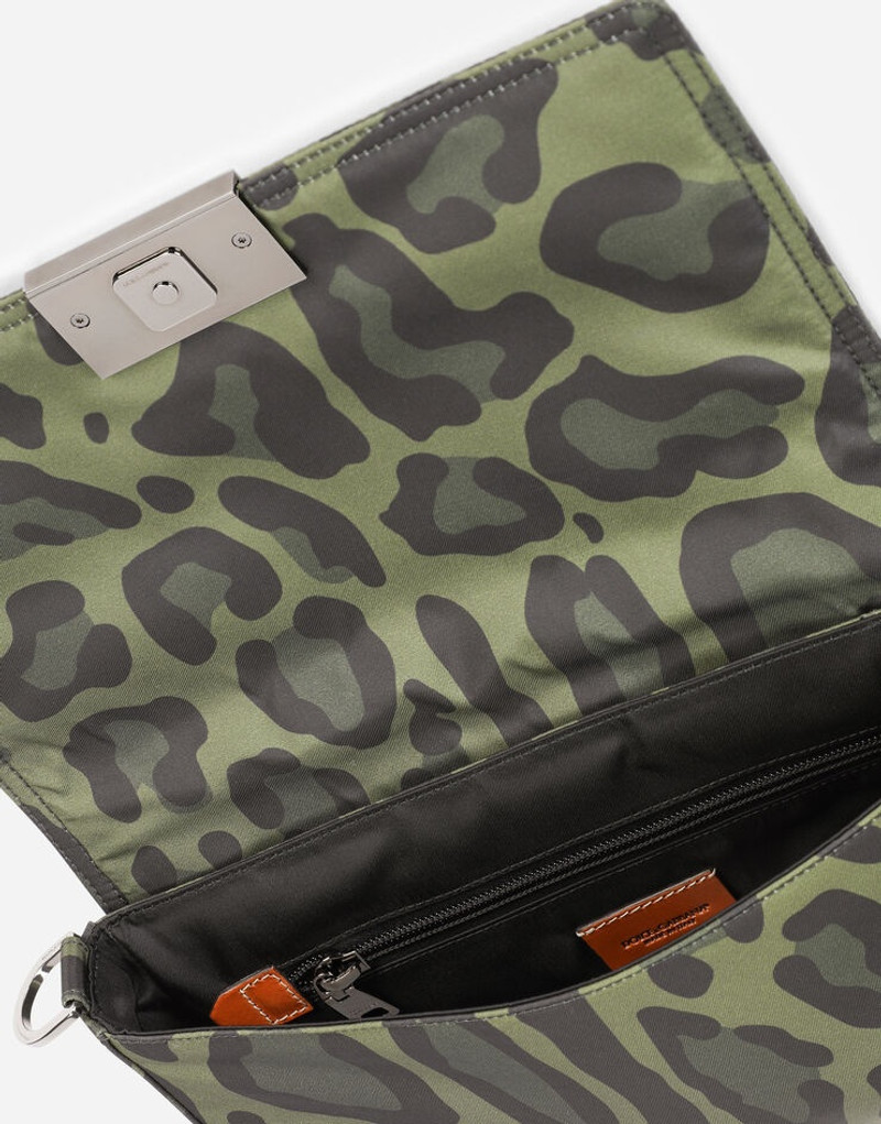 Nylon crossbody bag with leopard print against a green background and branded plate 5