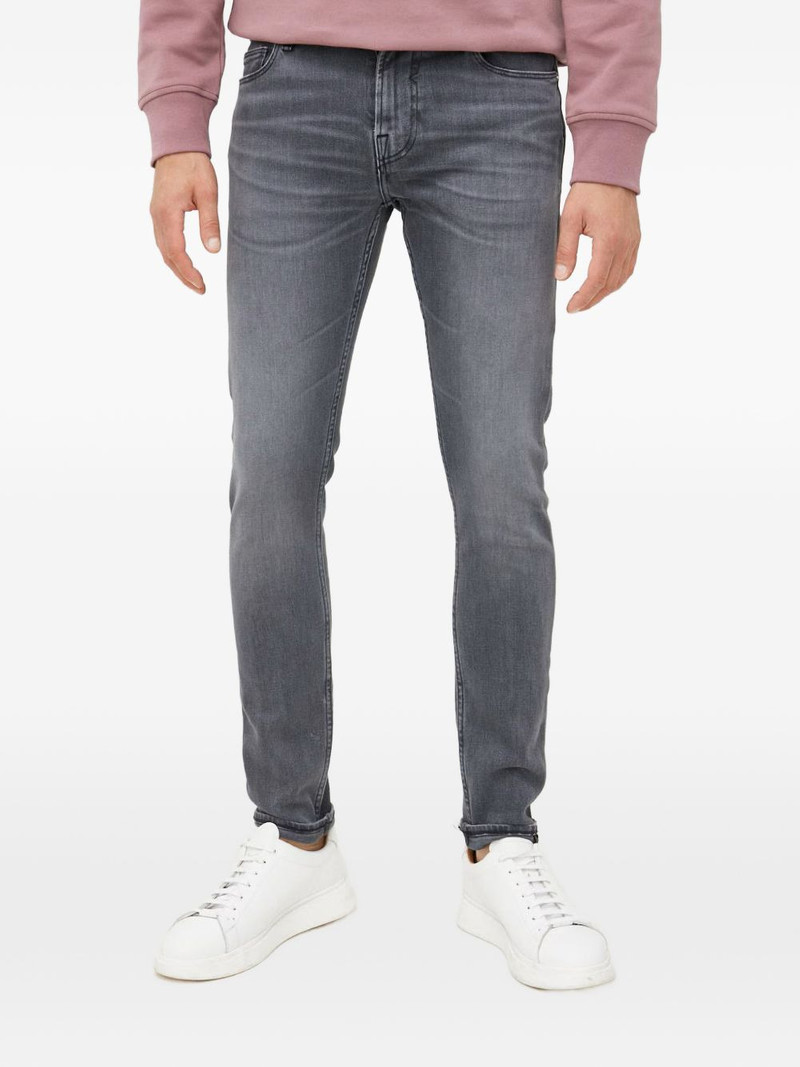 Chris triangle-logo jeans 1