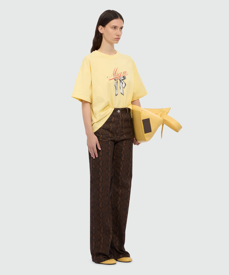 Yellow T-shirt with MSGM graphic print and bow. 4