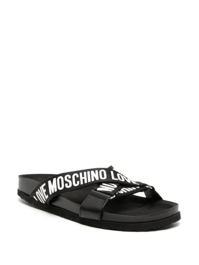 Moschino logo-print strappy slides outlook
