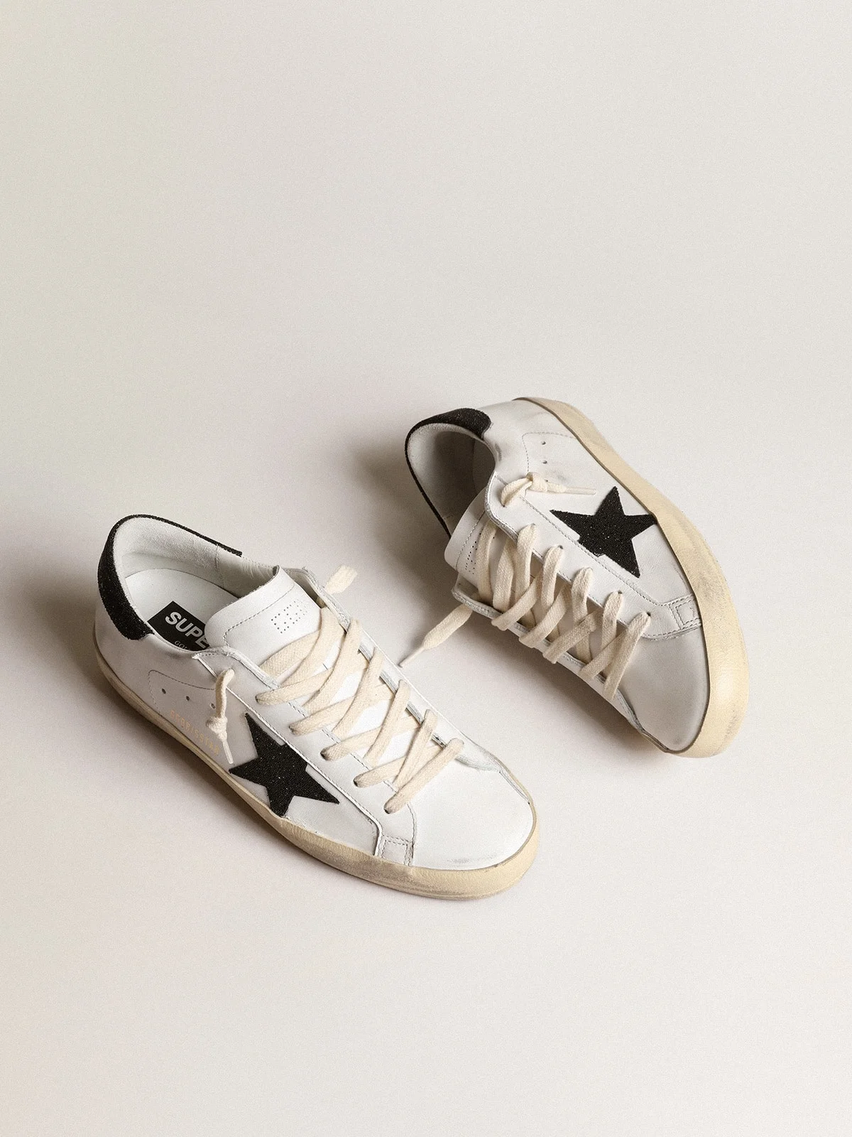 Golden Goose Super-Star with a black Swarovski crystal star and