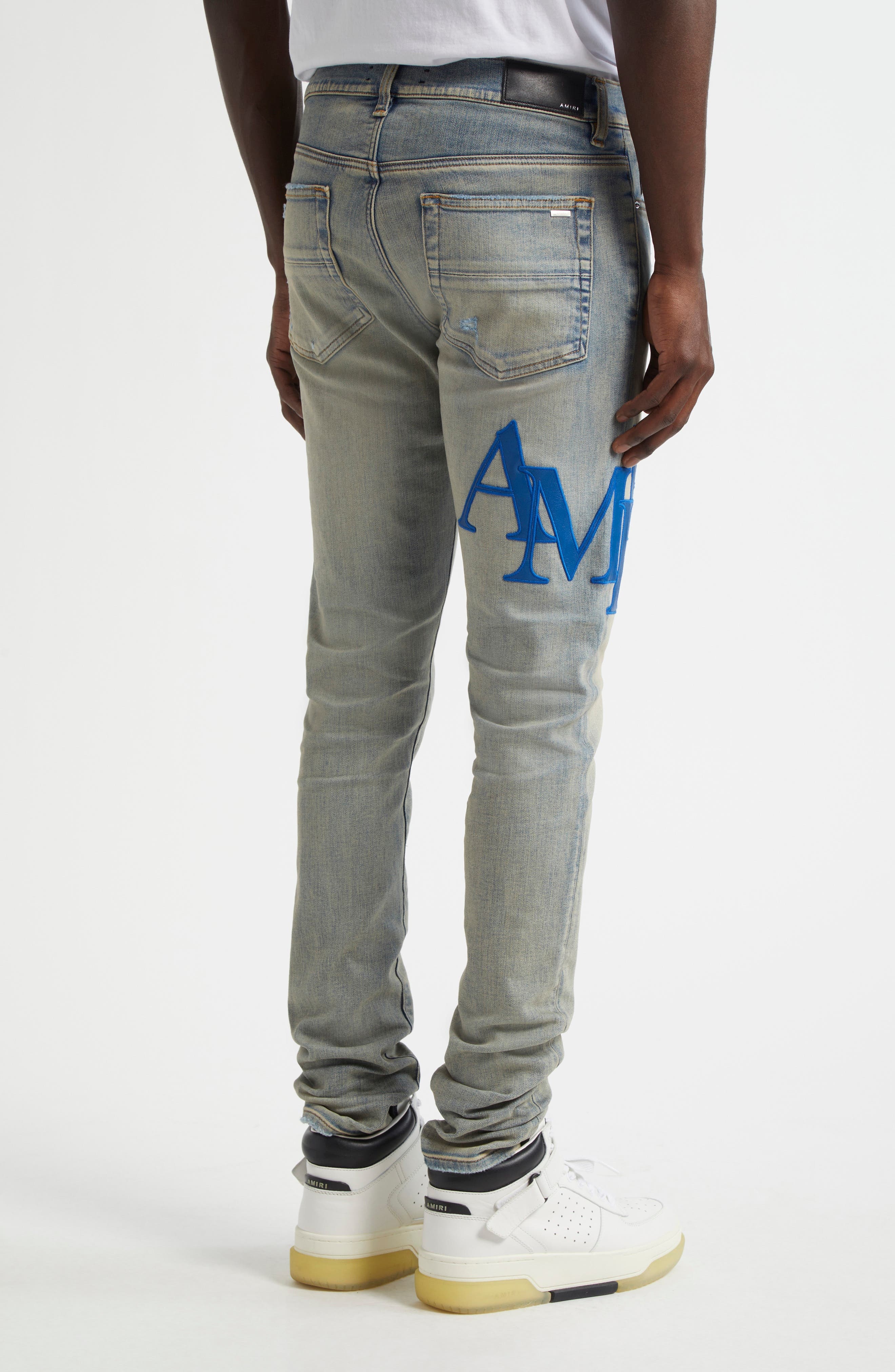 AMIRI Staggered Logo Skinny Jeans in Antique Indigo Blue at Nordstrom - 3