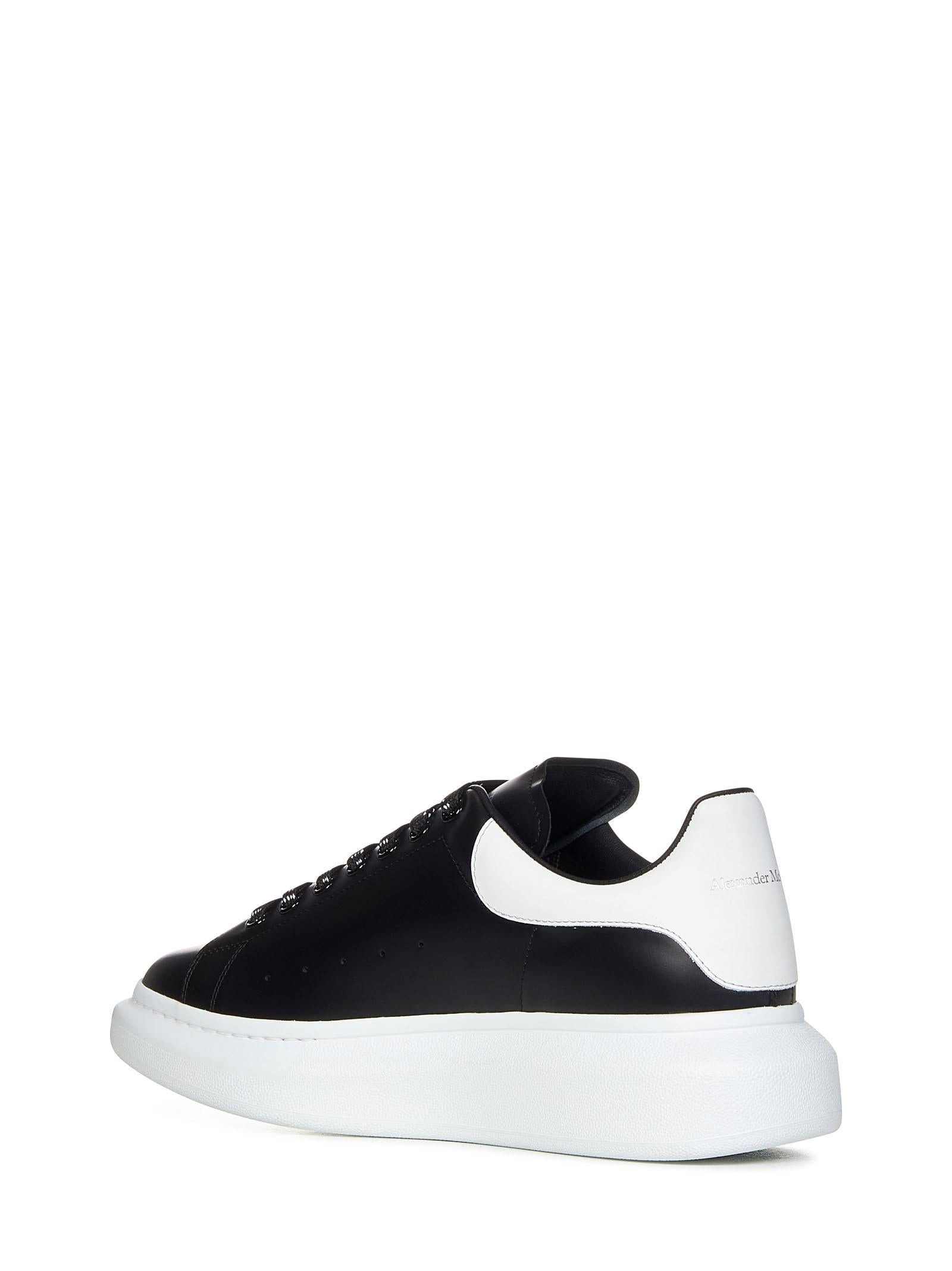Oversize black smooth leather sneakers with white leather detail on the heel. - 3