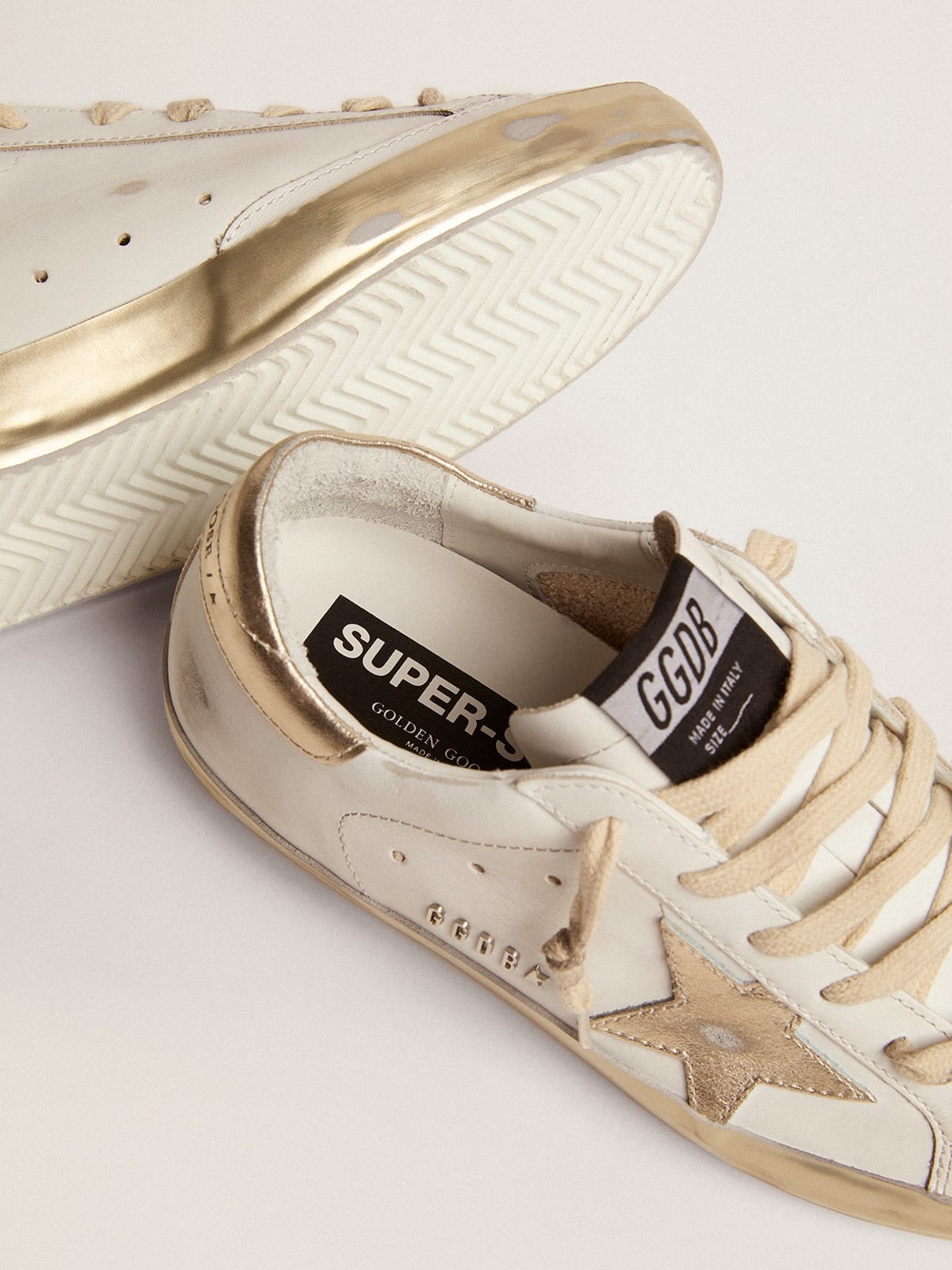 Women’s Super-Star sneakers with gold sparkle foxing and metal stud  lettering