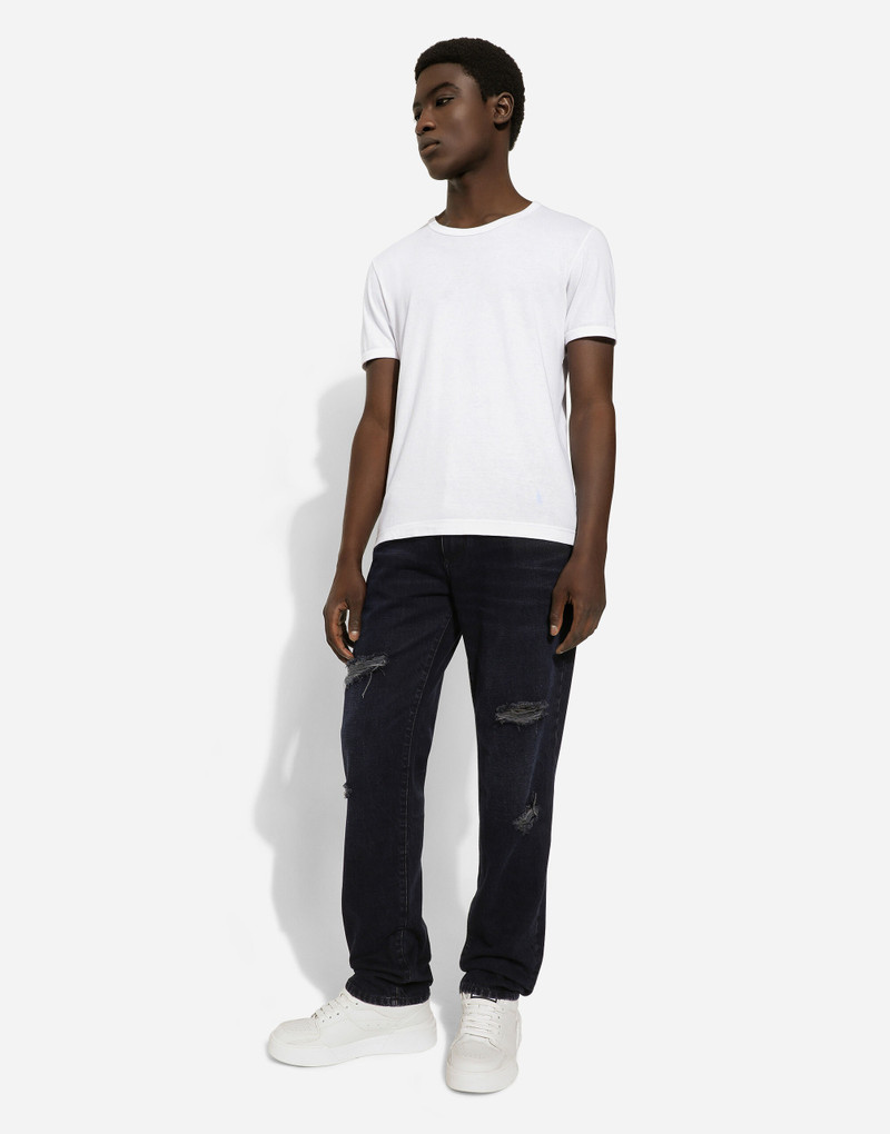 Blue denim jeans with abrasions and rips 5