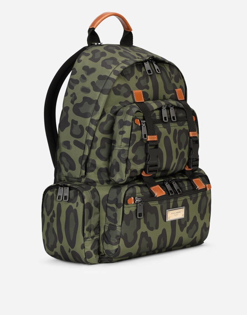 Nylon backpack with leopard print against a green background and branded plate 3