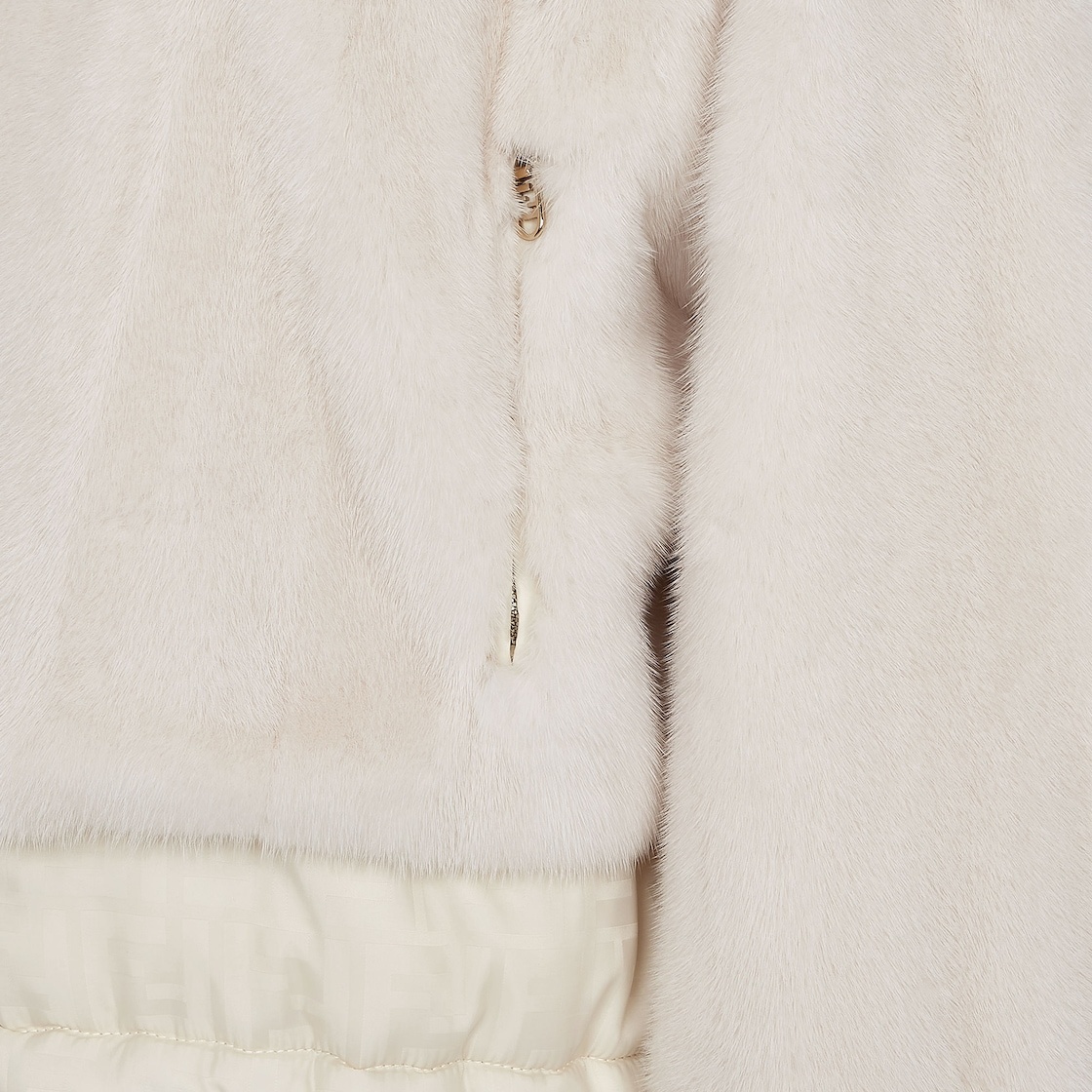 Reversible cropped jacket with high collar and drawstring hem. One side has zipper pockets, the othe - 3