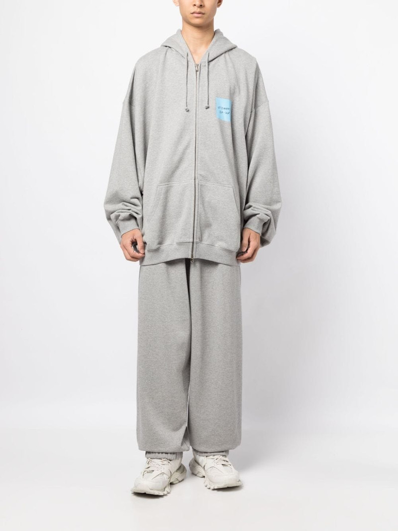 VETEMENTS logo-print wide-leg track pants outlook