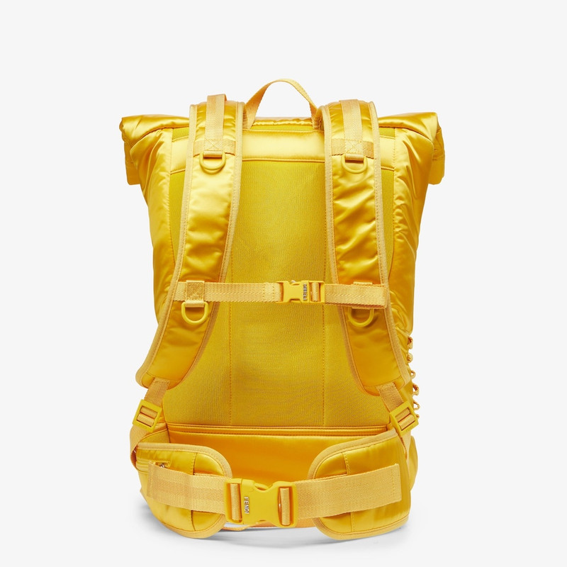 Rolltop backpack in yellow nylon, decorated with enameled tone on tone Baguette buckle. Button and h 3