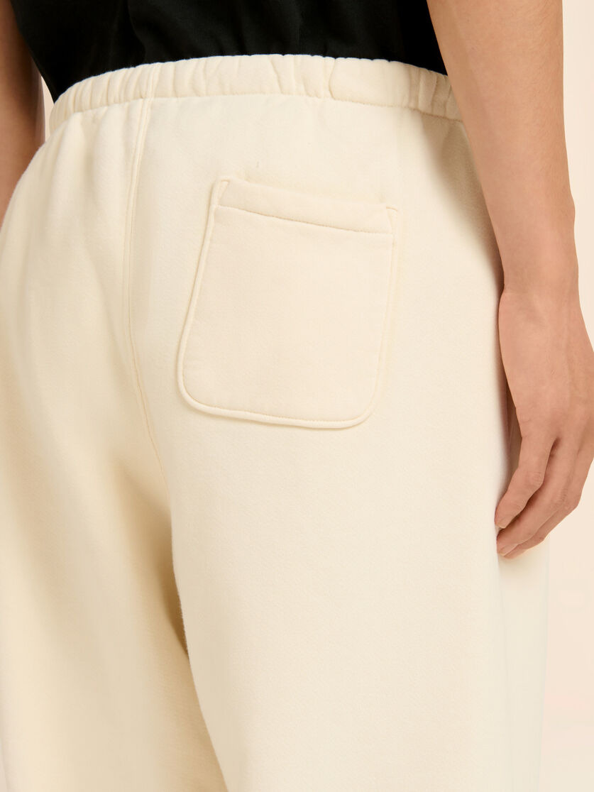 MARNI + MADHAPPY CREAM COTTON SWEATPANTS WITH ARCH LOGO PRINT - 4