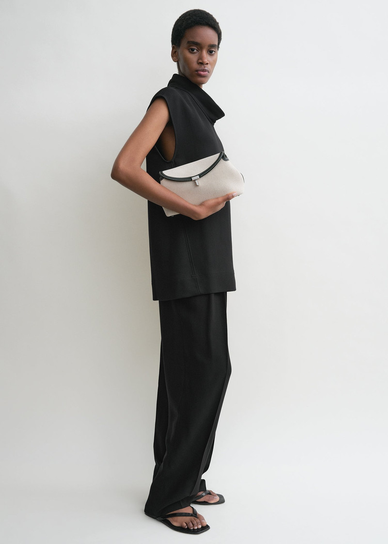 Totême T-Lock clutch ecru/black outlook