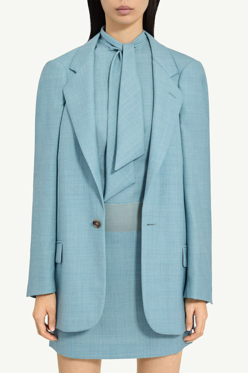 A flattened silhouette reworks classic tailoring by pressing structure into a more two-dimensional f 4