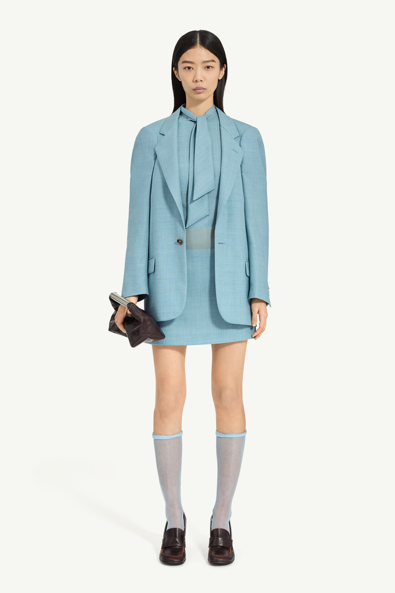 A flattened silhouette reworks classic tailoring by pressing structure into a more two-dimensional f 1