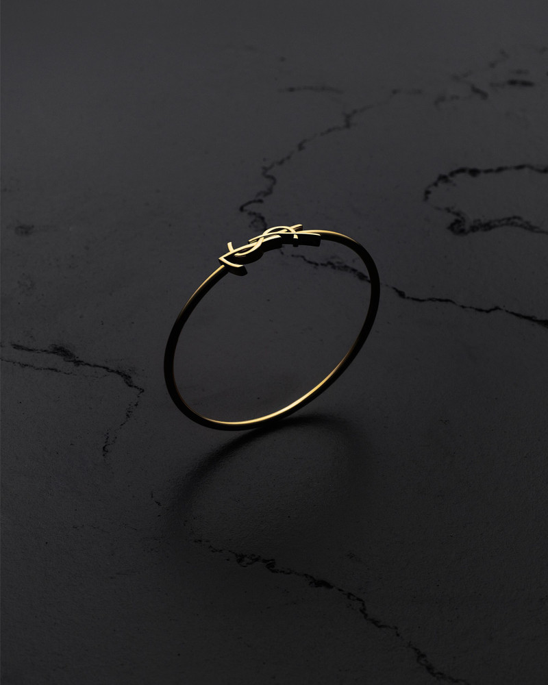SAINT LAURENT CASSANDRE HINGED BANGLE IN 18K YELLOW GOLD outlook