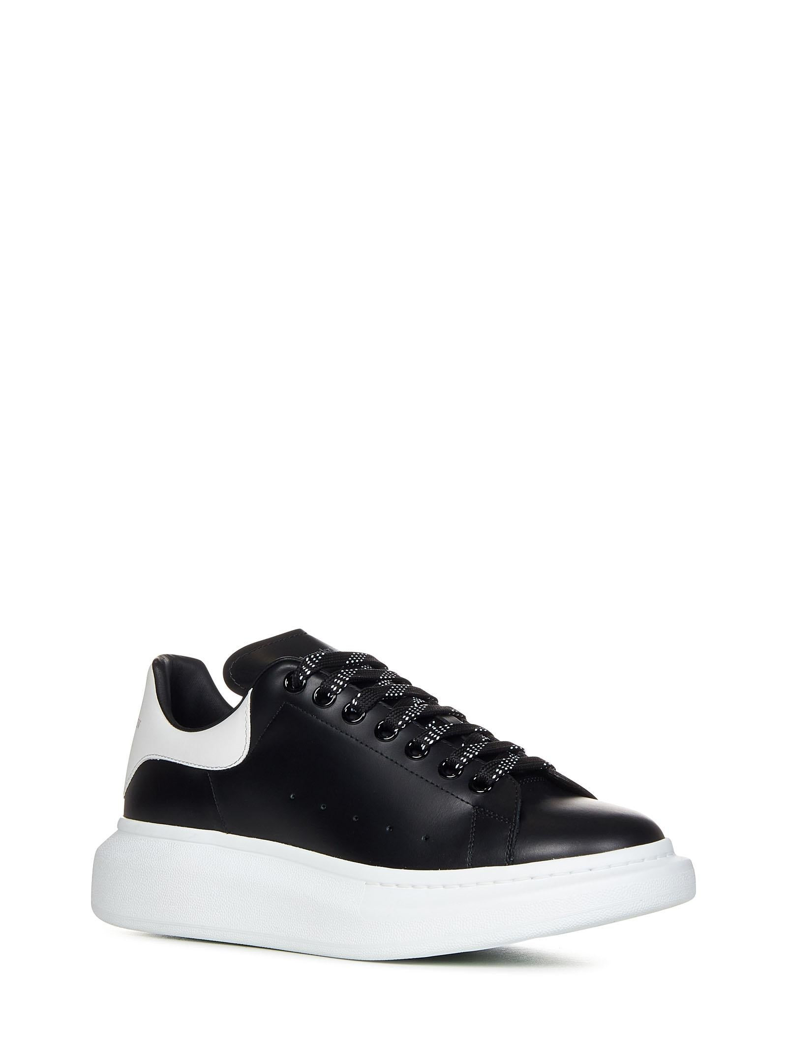 Oversize black smooth leather sneakers with white leather detail on the heel. - 2