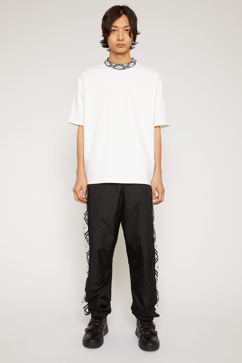 Acne Studios Face motif stripe track pants black outlook