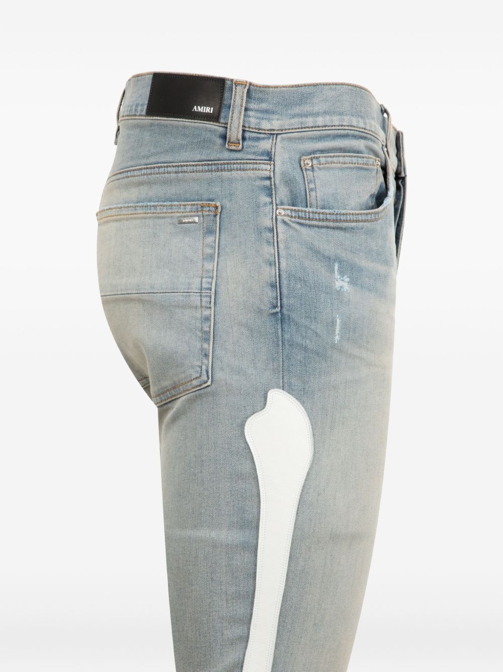 Bones-appliqué distressed skinny jeans - 3